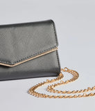 The Classically Chic Faux Leather Envelope Wristlet in black is a women's workwear piece offering a trendy style and unique accents, perfect for effortlessly creating an outfit-of-the-day look that transitions your office look to going-out ready.