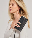 The Classically Chic Faux Leather Envelope Wristlet in black is a women's workwear piece offering a trendy style and unique accents, perfect for effortlessly creating an outfit-of-the-day look that transitions your office look to going-out ready.