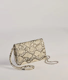 The Wildly Fab Faux Snake Print Wristlet in snake is a women's workwear essential with an elevated fabric and chic silhouette, ideal for layering and versatile enough to take your look from office chic to going-out ready!