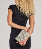 The Wildly Fab Faux Snake Print Wristlet in snake is a women's workwear piece offering a trendy style and unique accents, perfect for effortlessly creating an outfit-of-the-day look that transitions your office look to going-out ready.