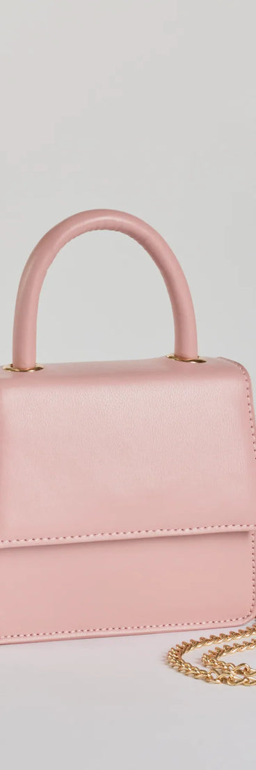 The Simply Tasteful Mini Faux Leather Purse in pink is a women's workwear essential with an elevated fabric and chic silhouette, ideal for layering and versatile enough to take your look from office chic to going-out ready!