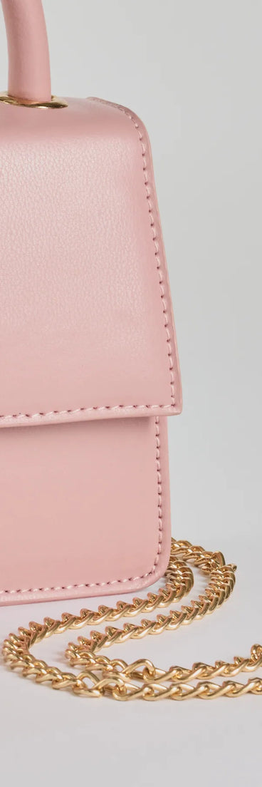 The Simply Tasteful Mini Faux Leather Purse in pink is a women's workwear piece offering a trendy style and unique accents, perfect for effortlessly creating an outfit-of-the-day look that transitions your office look to going-out ready.