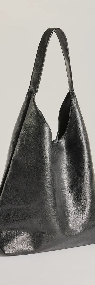 The Iconic Moment Faux Leather Slouchy Shoulder Bag in black is a women's workwear essential with an elevated fabric and chic silhouette, ideal for layering and versatile enough to take your look from office chic to going-out ready!