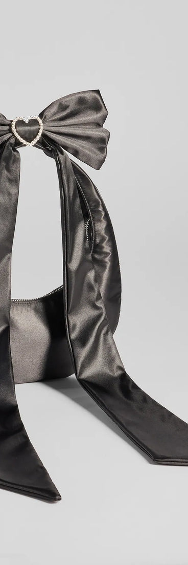 Whether you're dressing up for a romantic date or a Galentine's event, the Luxe Rhinestone Bow Strap Satin Shoulder Bag in black is the perfect accessory to elevate your Valentine's Day outfit.