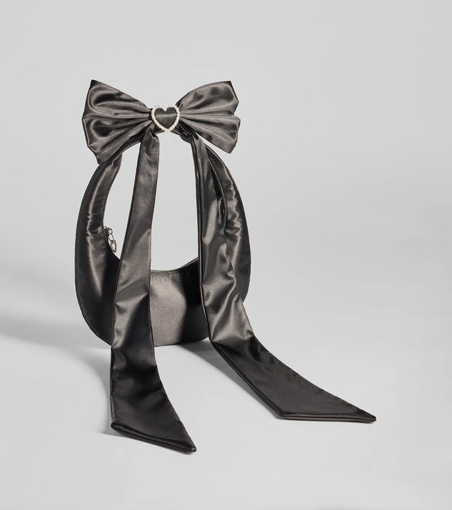 Whether you're dressing up for a romantic date or a Galentine's event, the Luxe Rhinestone Bow Strap Satin Shoulder Bag in black is the perfect accessory to elevate your Valentine's Day outfit.