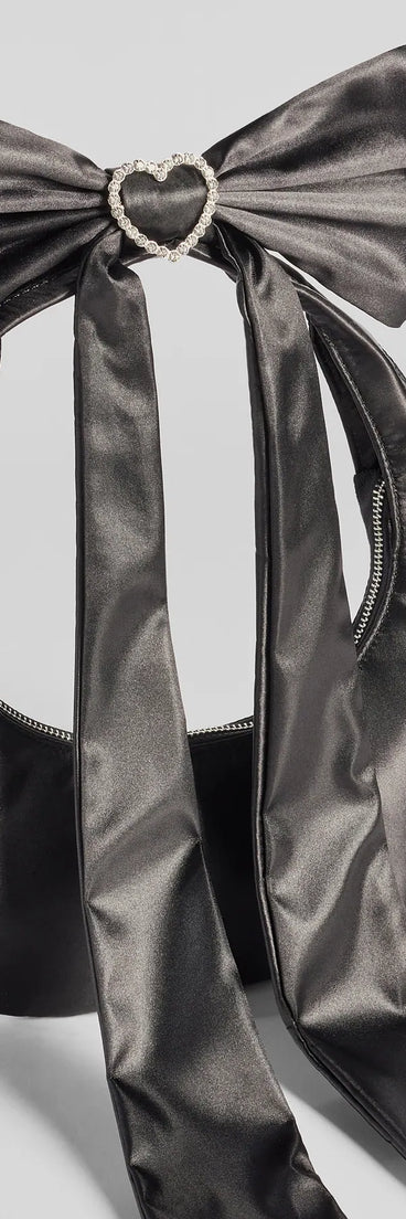 Whether you're dressing up for a romantic date or a Galentine's event, the Luxe Rhinestone Bow Strap Satin Shoulder Bag in black is the perfect accessory to elevate your Valentine's Day outfit.