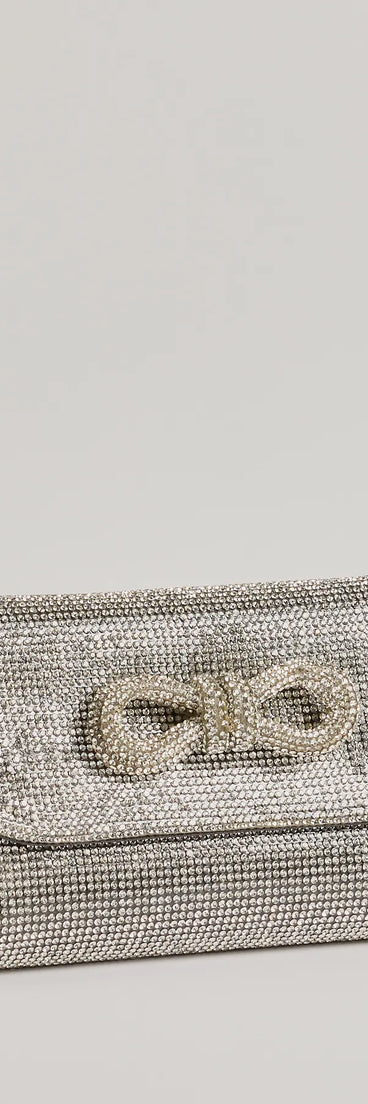 Get ready for any event with the Sparkle And Glow Rhinestone Bow Handbag in silver, an essential start to creating a versatile holiday outfit for women for holiday parties, cocktail hours, or NYE events.