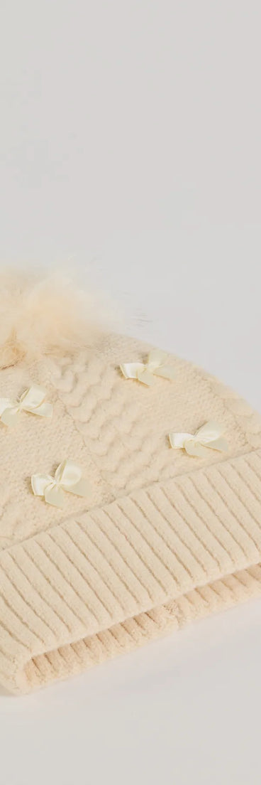 Add a touch of seasonal charm to your winter wardrobe with the Stay Toasty Bow And Pom Knit Beanie, a ivory cold-weather accessory that effortlessly completes your seasonal looks!