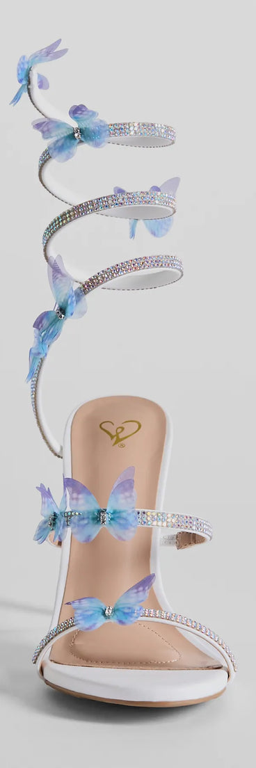 Elevate warm-weather looks with Mythical Babe Butterfly Rhinestone Spiral Stiletto Heels in white, a pair of trendy sandals bringing chic, modern flair to every step.
