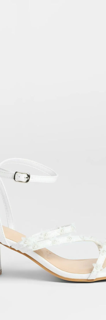 Elevate warm-weather looks with Chic Bloom Flower Strappy Block Heels in white, a pair of trendy sandals bringing chic, modern flair to every step.