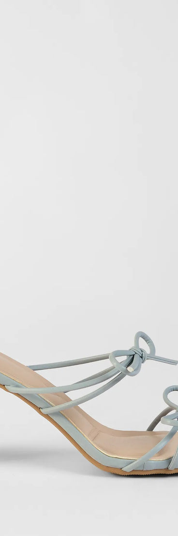 Elevate warm-weather looks with Finest Hour Bow Strappy Mules in blue, a pair of trendy sandals bringing chic, modern flair to every step.