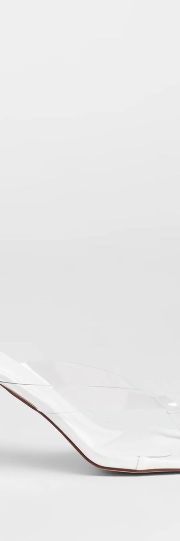 Elevate warm-weather looks with Sleek And Stunning Thong Stiletto Mules in white, a pair of trendy sandals bringing chic, modern flair to every step.