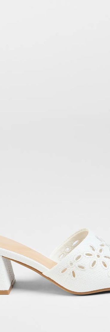 Elevate warm-weather looks with Perfect Pair Cutout Block Heel Mules in white, a pair of trendy sandals bringing chic, modern flair to every step.