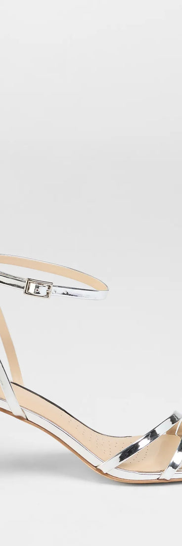 Elevate warm-weather looks with So Obsessed Metallic Strappy Block Heels in silver, a pair of trendy sandals bringing chic, modern flair to every step.