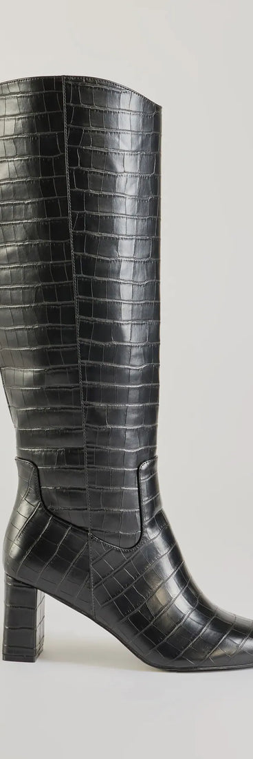 The Bold Statement Faux Leather Croc-Embossed Under the Knee Boots are women's black shoes for work, featuring a sleek silhouette and cushioned sole for all-day comfort, and are a trendy choice for professional or business casual outfits.