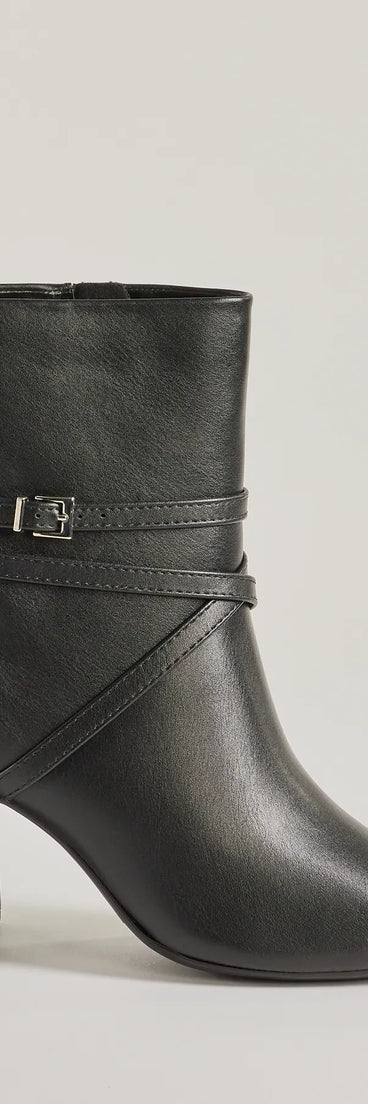 The Stylish Stride Strappy Faux Leather Booties are women's black shoes for work, featuring a sleek silhouette and cushioned sole for all-day comfort, and are a trendy choice for professional or business casual outfits.