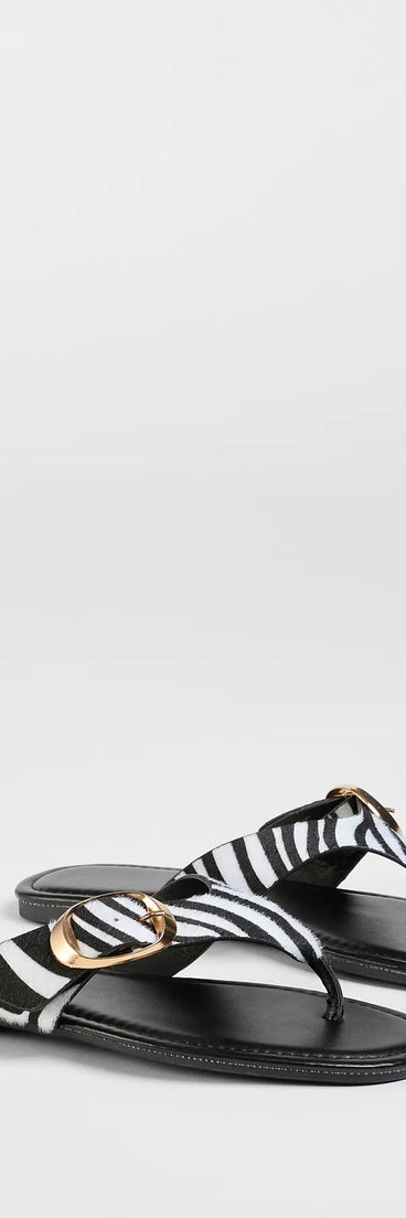 Elevate warm-weather looks with Statement Gleam Buckle Thong Sandals in zebra print, a pair of trendy sandals bringing chic, modern flair to every step.