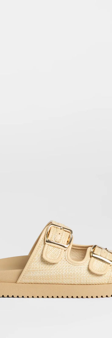 Elevate warm-weather looks with Under The Sun Straw Buckle Slide Sandals in beige, a pair of trendy sandals bringing chic, modern flair to every step.