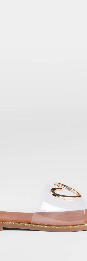 Elevate warm-weather looks with Totally Heart Flat Sandals in clear, a pair of trendy sandals bringing chic, modern flair to every step.