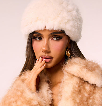 Discover cold weather accessories featuring cozy faux fur hats, plush textures, and sophisticated details made for stylish layering.