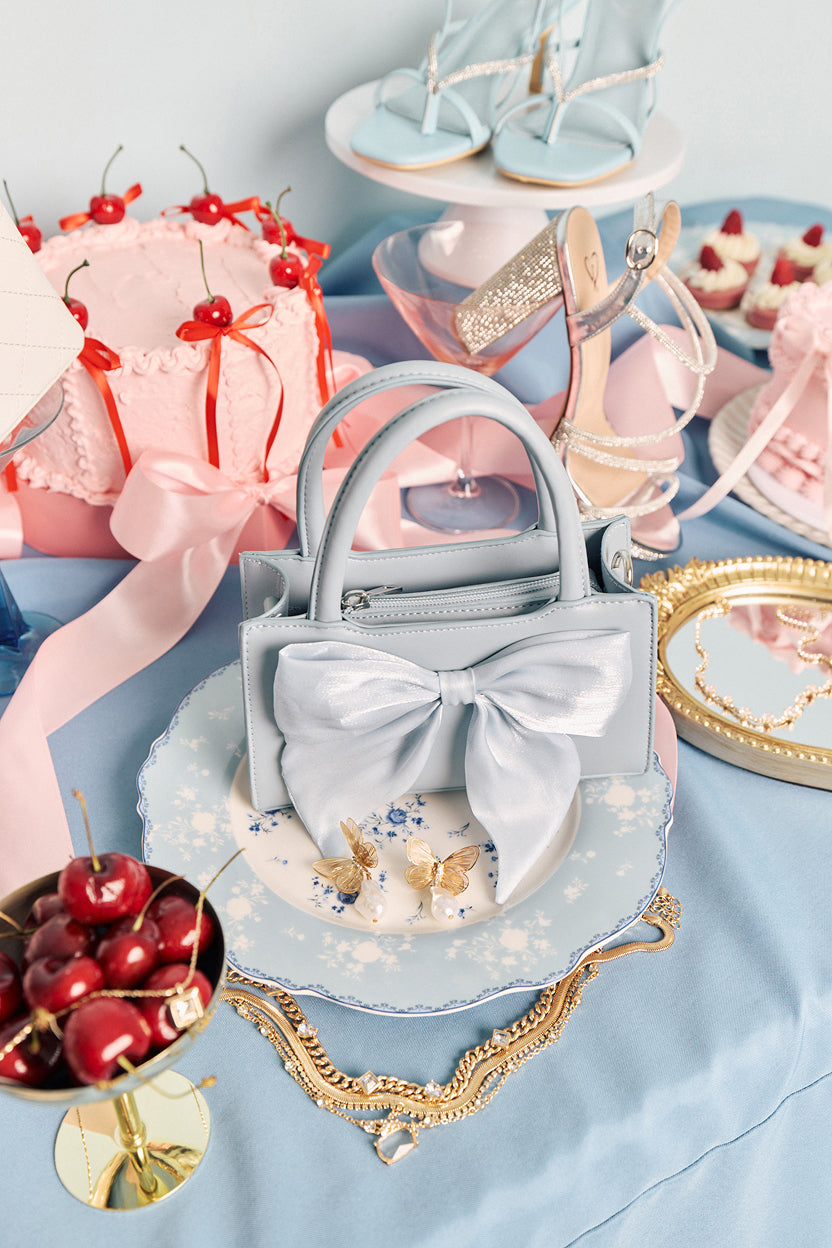 Shop prom accessories with bow mini bags, delicate jewelry, and polished details for the perfect finishing touch.