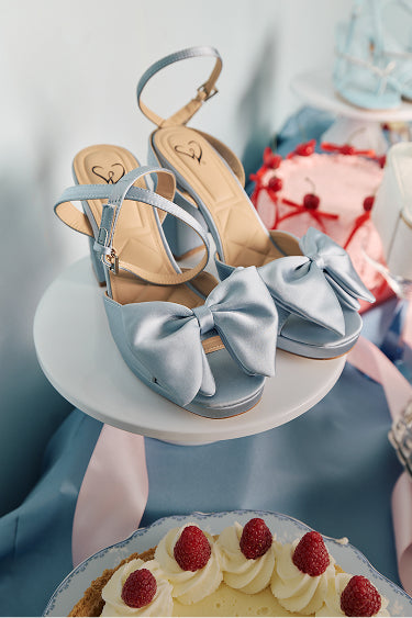 Heel yes—prom shoes with satin & metallic finishes, oversized bows and accents, and feminine details that elevate every step.