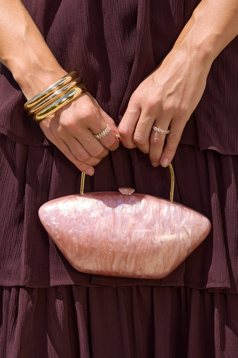 Discover women’s accessories featuring marbled handbags, sparkling rings, and elevated warm-weather styling.
