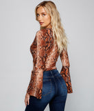 With fun and flirty details, She's Stylin' Snake Print Top shows off your unique style for a trendy outfit for the summer season!