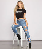 Good Witch Bad B*tch Black Graphic Tee styled by Windsor with Large Silver Hoop Earrings, Distressed Denim Jeans, and Black Booties