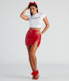 Women’s Halloween party outfit styled as a devil costume with a crop graphic print tee that says “Diablita” styled with costume devil horns, extra large hoop earrings, and a red faux leather mini skirt