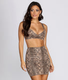 With fun and flirty details, Statement Snake Bustier Crop Top shows off your unique style for a trendy outfit for the summer season!