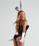 Removable costume bunny tail on black satin bodysuit from Windsor’s bunny costumes for Halloween 2022 styled with white satin gloves, silver bunny ears, rhinestone white fishnet tights, and rhinestone costume jewelry