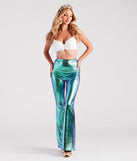 Women’s white rhinestone mermaid costume bra styled for an adult Halloween costume idea with a seashell crown, flare pants with an iridescent fish scale print, gold metallic heels, and costume jewelry. 