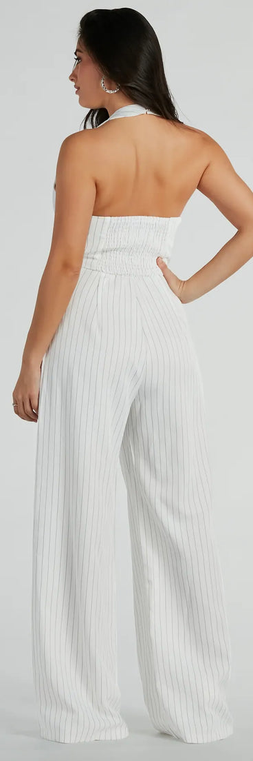 The Getaway Vibes Wide-Leg Pinstripe Woven Jumpsuit is an elevated one-piece that blends sleek sophistication with playful charm, perfect for nailing casual or formal outfits.