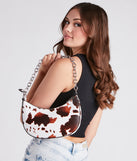 Greener Pastures Cow Print Shoulder Bag is a fire pick to create 2023 festival outfits, concert dresses, outfits for raves, or to complete your best party outfits or clubwear!