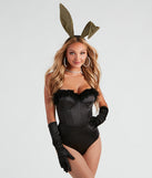 Women’s bunny costume styled with gold glitter bunny ears, rhinestone costume jewelry, black satin gloves, white fishnet tights with rhinestones, and a furry trim bodysuit
